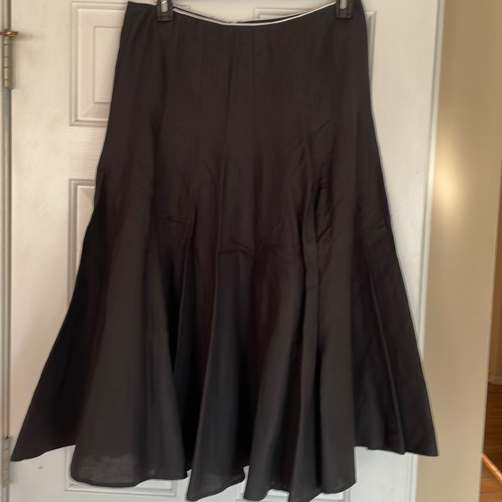 Black full skirt with white piping along the top of the waist.